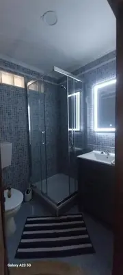 a bathroom with a shower and a toilet and a sink at Casa Mestre Guesthouse in Vila do Bispo