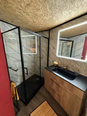 a bathroom with a shower and a sink and a mirror at Casa Mestre Guesthouse in Vila do Bispo