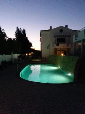 a swimming pool in front of a house at night at Casa Carmela in Burgau