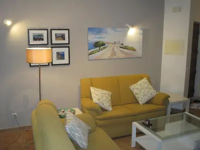 a living room with a couch and a table at Casa Carmela in Burgau
