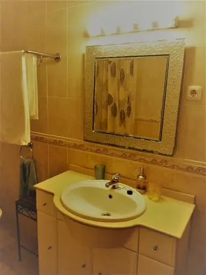 a bathroom with a sink and a mirror at Casa Carmela in Burgau