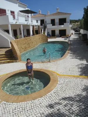 a woman is sitting in a swimming pool at Casa Carmela in Burgau