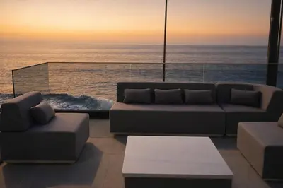 a living room with a couch and a view of the ocean at Villa Sunset Avenue in Paul do Mar