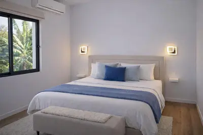 a bedroom with a large bed and a window at Villa Sunset Avenue in Paul do Mar
