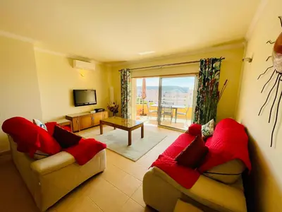 a living room with two couches and a television at Vila das Acacias in Luz