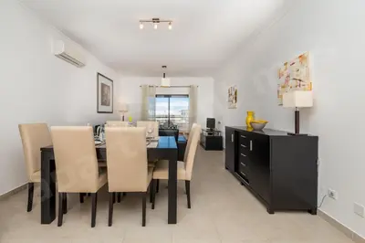 a dining room with a black table and chairs at Apartment Mos in Lagos