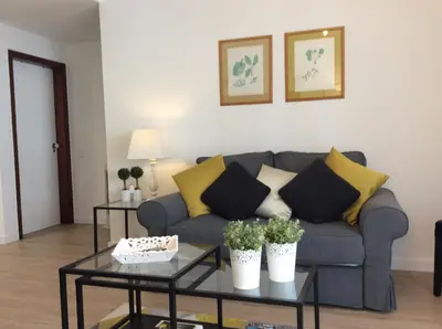a living room with a couch and two tables at Cosy Studio at Lido with Pool in Funchal
