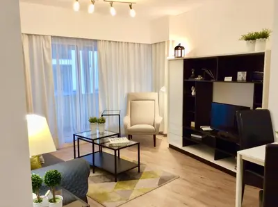 a living room with a couch chair and a television at Cosy Studio at Lido with Pool in Funchal