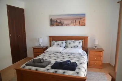 a bedroom with a bed with two pillows on it at Casa Flora T1 - Vila do Bispo in Vila do Bispo