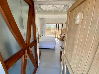 a view of a bedroom with a bed and a window at Hortas do Rio - Casa de Campo in Carrapateira