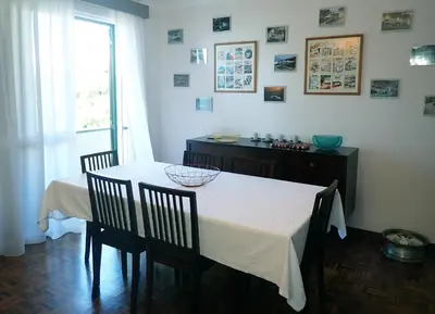 a dining room with a table and chairs and a window at Funchal petrolhead apartment in Funchal
