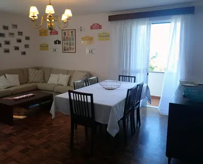 a living room with a table and a couch at Funchal petrolhead apartment in Funchal