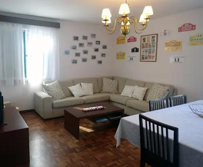 a living room with a couch and a table at Funchal petrolhead apartment in Funchal