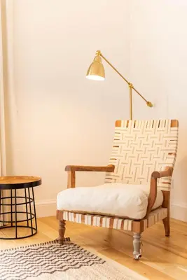 a living room with a chair and a lamp at Apartamentos Ferreiros by Heart of Funchal in Funchal