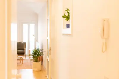 a hallway with a door with a plant on the wall at Apartamentos Ferreiros by Heart of Funchal in Funchal