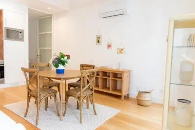 a dining room with a table and chairs at Apartamentos Ferreiros by Heart of Funchal in Funchal