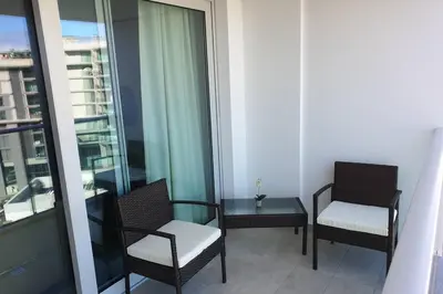 a room with two chairs and a table on a balcony at Sarah House in Funchal