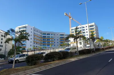 a street with cars parked in front of a building at Sarah House in Funchal