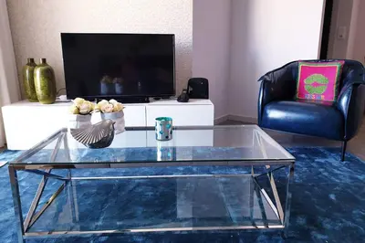 a glass coffee table in a living room with a tv at Sarah House in Funchal