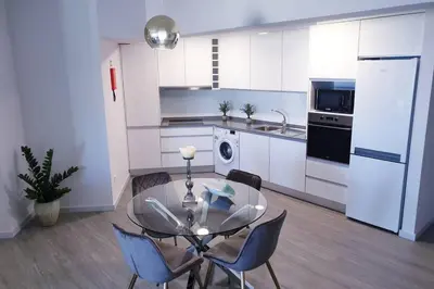 a kitchen with a glass table and chairs at Sarah House in Funchal