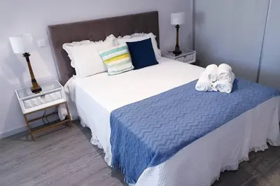 a bedroom with a large bed with towels on it at Sarah House in Funchal