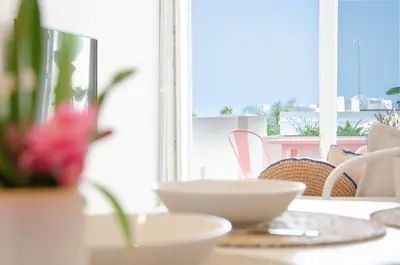 a table with two white bowls on top of it at Casa da Praia - Lagos in Lagos