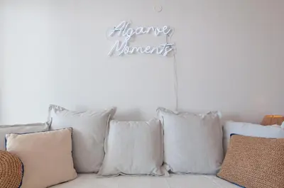 a group of pillows sitting on a couch with a sign at Casa da Praia - Lagos in Lagos
