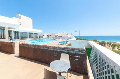 a balcony with a table and a view of the ocean at Casa da Praia - Lagos in Lagos