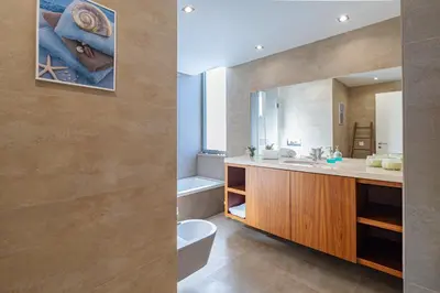 a bathroom with a sink and a toilet and a mirror at Villa Blue Sagres G in Sagres