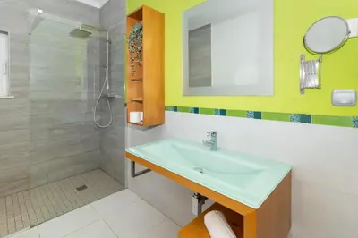 a bathroom with a sink and a shower at Villa Farol in Sagres