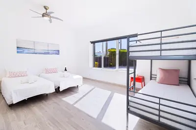 a bedroom with two bunk beds and a couch at Villa Farol in Sagres