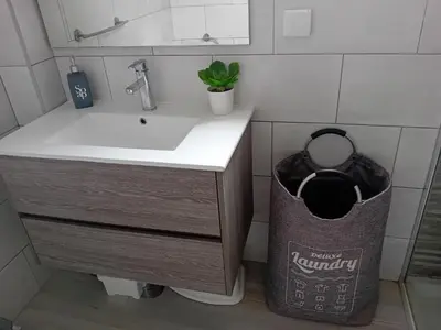 a bathroom with a sink and a trash can at Burgau Mar in Burgau