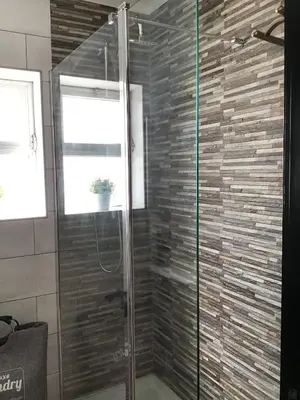 a shower with a glass door in a bathroom at Burgau Mar in Burgau