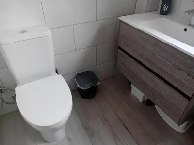 a bathroom with a white toilet and a sink at Burgau Mar in Burgau