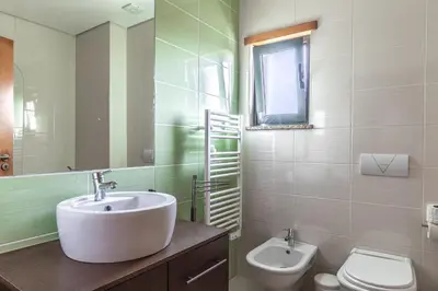 a bathroom with a sink and a toilet at Apartamento 7 Mares in Sagres