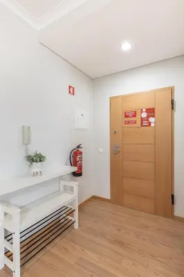 a room with a table and a wooden door at Apartamento 7 Mares in Sagres