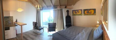 a bedroom with a bed and a desk and a window at Quinta dos Artistas in Santa Cruz