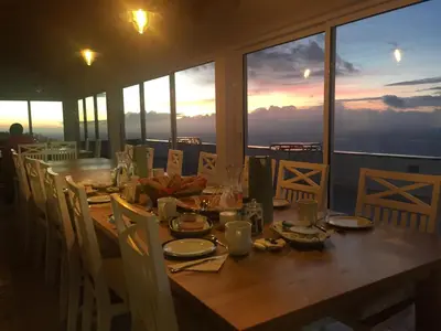 a dining room table with a view of the city at Quinta dos Artistas in Santa Cruz
