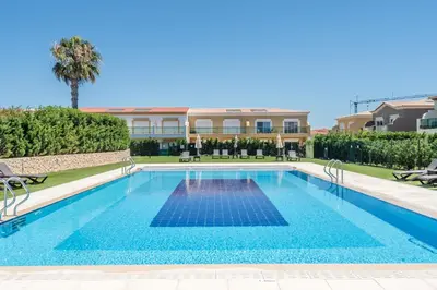 a swimming pool in front of a building at Boavista Resort - Casa Belinda in Lagos