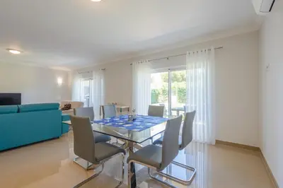 a dining room with a glass table and chairs at Boavista Resort - Casa Belinda in Lagos