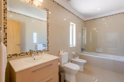 a bathroom with a sink and a toilet and a tub at Boavista Resort - Casa Belinda in Lagos