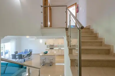a staircase in a room with a table and chairs at Boavista Resort - Casa Belinda in Lagos