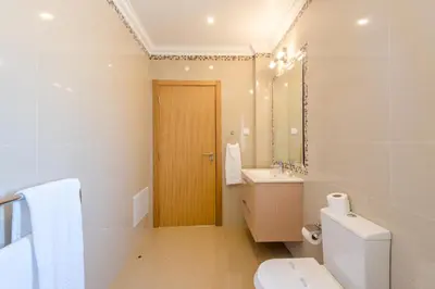 a bathroom with a toilet and a sink and a mirror at Boavista Resort - Casa Belinda in Lagos