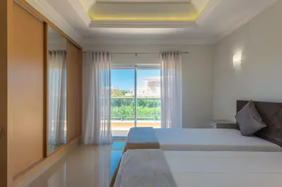 a bedroom with a bed and a large window at Boavista Resort - Casa Belinda in Lagos