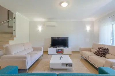 a living room with two couches and a tv at Boavista Resort - Casa Belinda in Lagos