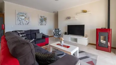 a living room with a couch and a tv at Casa Del Sol by LovelyStay in Relógio do Poiso