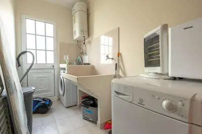 a kitchen with a sink and a washing machine at Casa Del Sol by LovelyStay in Relógio do Poiso