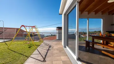 a patio with a swing set on a balcony at Casa Del Sol by LovelyStay in Relógio do Poiso