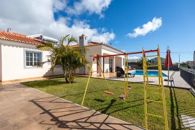 a backyard with a swing set and a playground at Casa Del Sol by LovelyStay in Relógio do Poiso