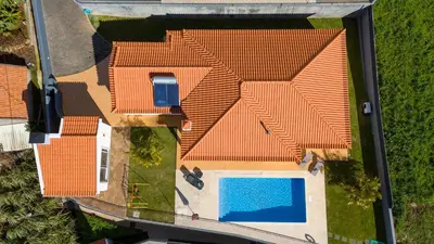 an overhead view of a house with an orange roof and a swimming pool at Casa Del Sol by LovelyStay in Relógio do Poiso
